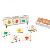 Wooden feelings chart on a white background with "excited," "proud," and "curious" tokens, and others scattered nearby.