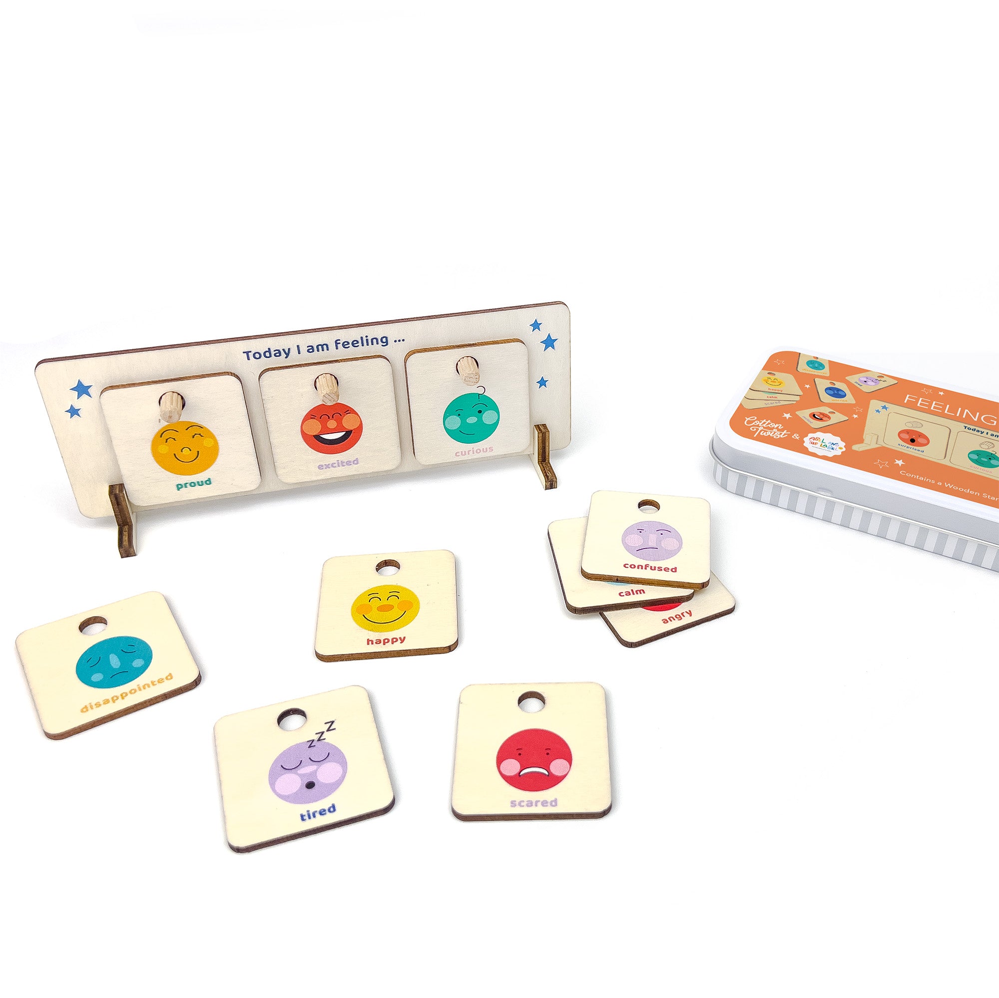 Wooden feelings chart on a white background with "excited," "proud," and "curious" tokens, and others scattered nearby.
