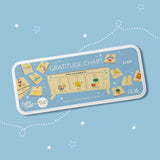 Personalised Gratitude Chart tin with illustrated wooden tokens and a display stand, shown on a starry blue background.