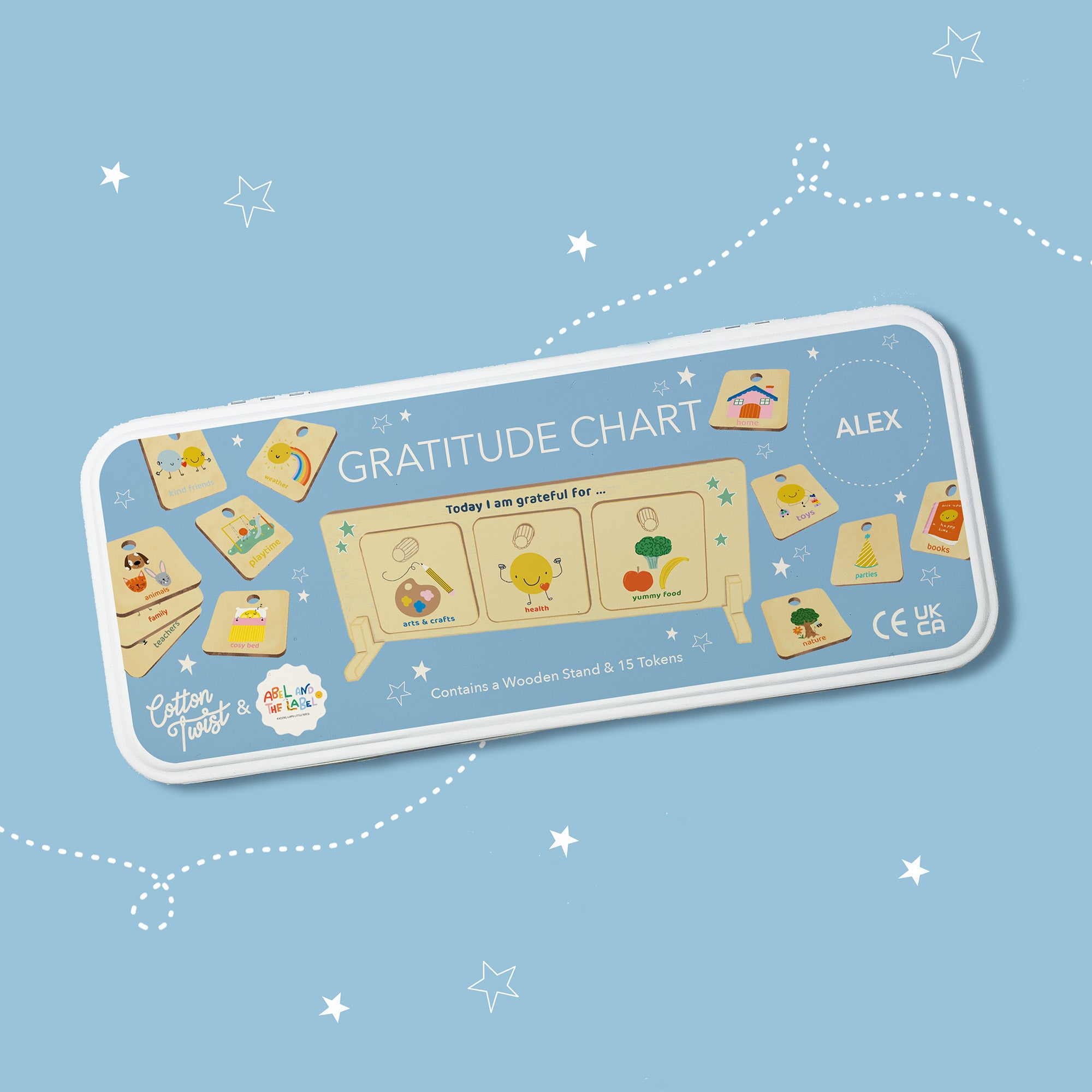 Personalised Gratitude Chart tin with illustrated wooden tokens and a display stand, shown on a starry blue background.