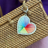 Finished wooden heart keyring featuring stitched patterns in colourful threads.