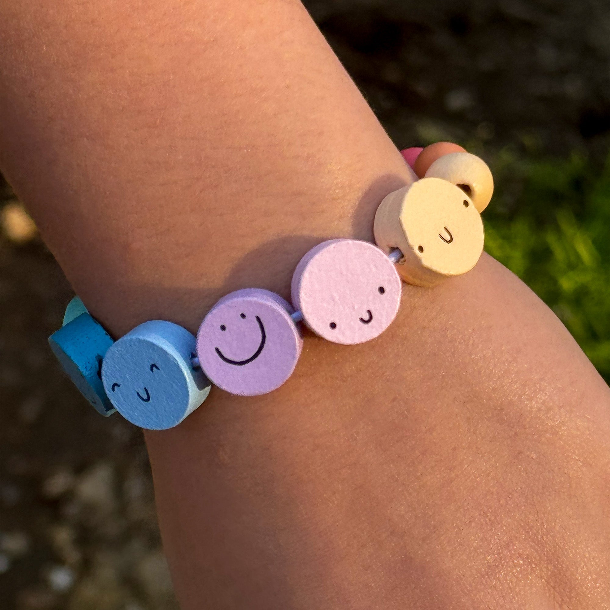 Completed smiley face bracelet on child's wrist