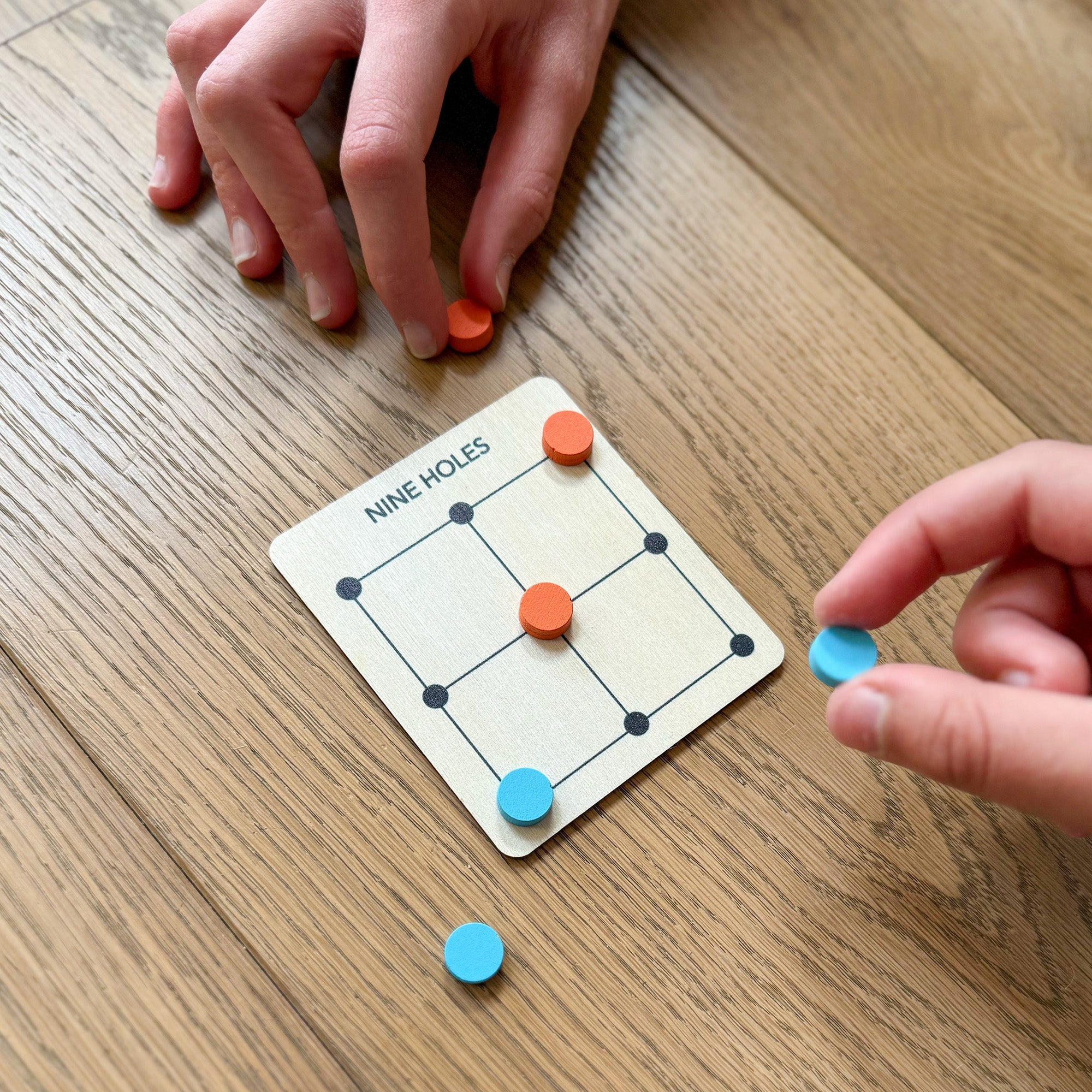 Nine Holes game with wooden board and tokens