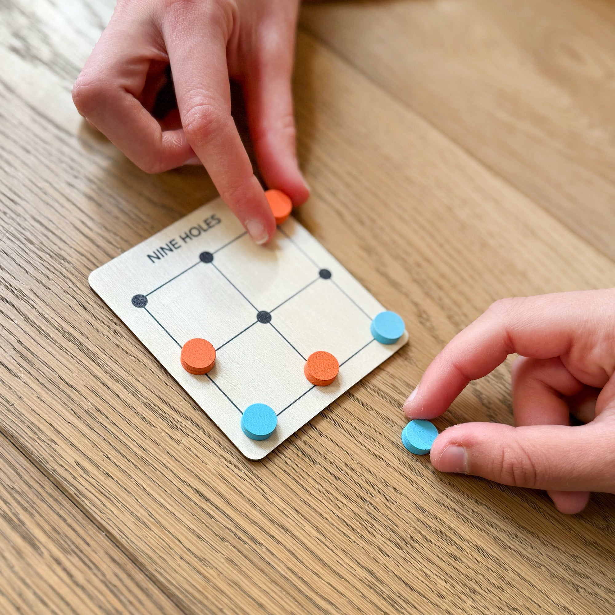 Nine Holes game with wooden board and tokens
