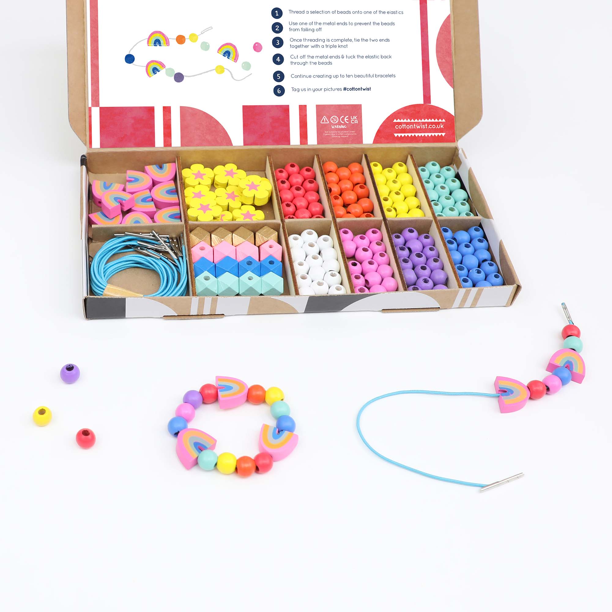 Beading kit shown with two finished bracelets and extra loose beads arranged on a white surface.