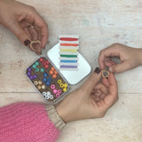 adult and child making a bracelet together